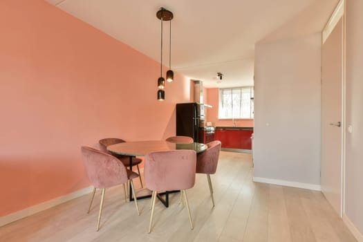a dining room with pink walls and a dining table