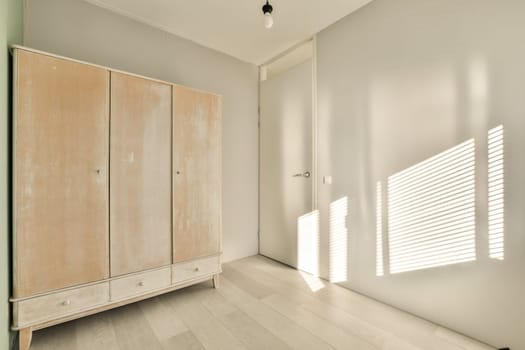 a bedroom with a wardrobe and blinds on the
