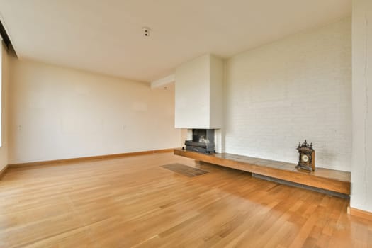 a living room with a fireplace and a wooden floor