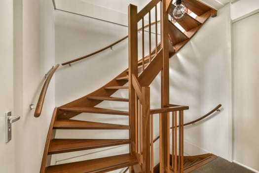 a spiral staircase in a home with wood and metal