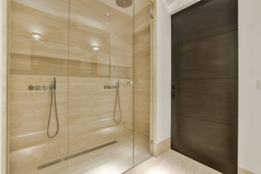 a bathroom with a shower and a wooden door