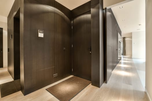 a row of dark wood elevators in a lobby