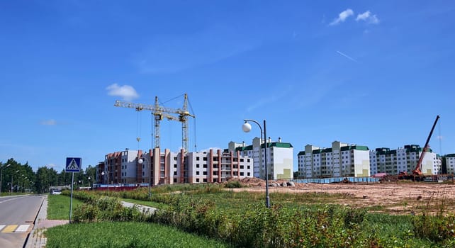Panoramic view of construction sites and many cranes working