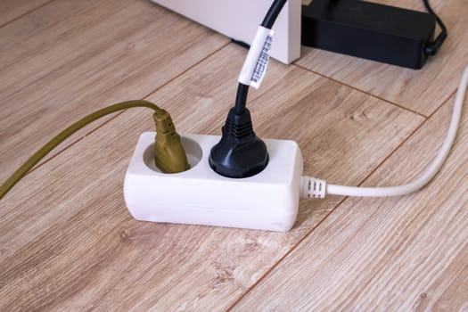 Extension cord with two sockets on the floor