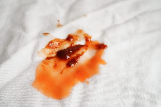 Dirty tomato sauce stain or ketchup on cloth to wash with washing powder, cleaning housework concept.