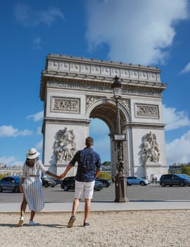 Couple on a citytrip in Paris visiting Avenue des Champs-Elysees Paris France Arc De Triomphe