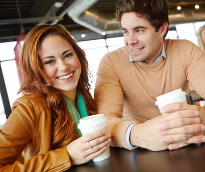 This date is perfect. A happy young couple on a date in a coffee shop.