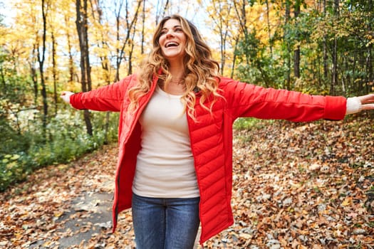 Feeling free. an attractive young woman standing with her arms outstretched in the forest during autumn.