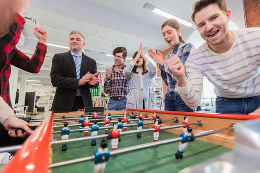 Employees playing table soccer