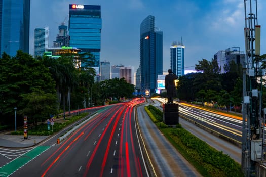 Jakarta, Indonesia. April 23, 2023. The city light trails against the buildings. On Jalan Jenderal Sudirman. Jakarta. Long Exposure Photography. Motion blur.