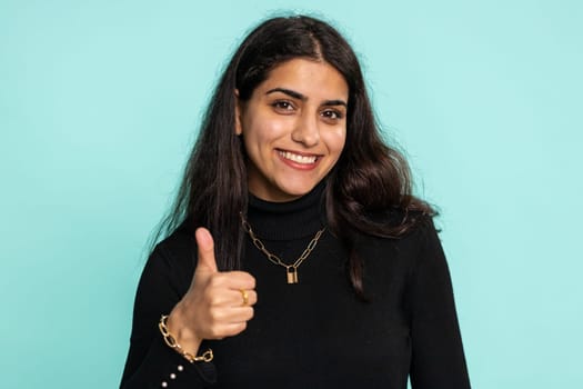 Indian woman raises thumbs up agrees or gives positive reply recommends advertisement likes good