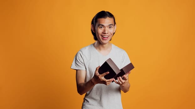 Excited male model receiving present in box