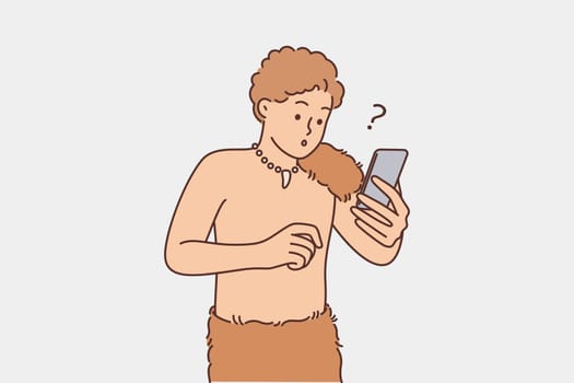 Primitive man with phone is surprised and shocked to see modern technology for first time