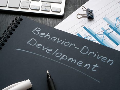 Desk with notepad and marks about behavior driven development BDD.