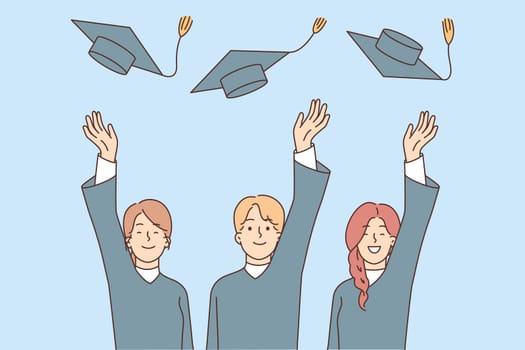 Graduates toss hats after graduation from university and celebrate receiving in-demand profession