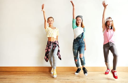 Dancing lifts the spirit. young girls dancing in a dance studio.