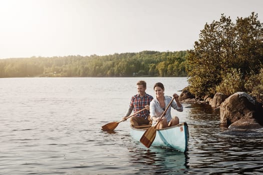 Life is one relaxing canoe ride. a young couple going for a canoe ride on the lake.