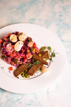 salad vinaigrette with black bread on a plate