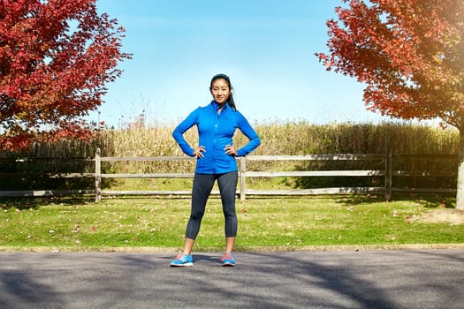 Youll need discipline if you want to get far. Portrait of a sporty young woman standing outdoors.
