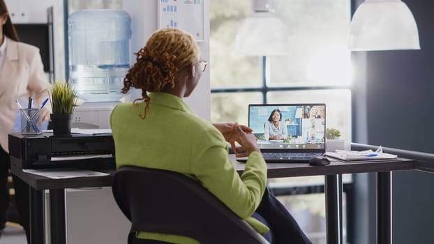 Young woman attending corporate meeting video call