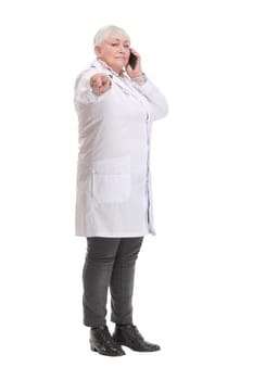Portrait of middle aged female doctor talking with somebody on her mobile phone.