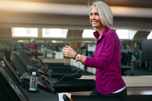 Making fitness a beneficial part of her lifestyle. a mature woman exercising on a treadmill at the gym.
