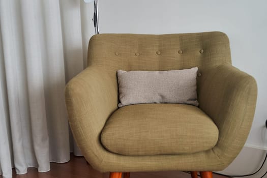 View of stylish green armchair in interior