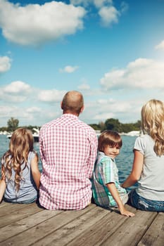 Making memories for life. a family on a pier while out by the lake.
