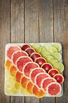 From sweet to sour, but oh so juicy. a variety of citrus fruits cut into slices on a plate.