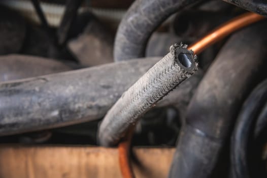 Old fuel hoses in a workshop, in selective focus. car waste