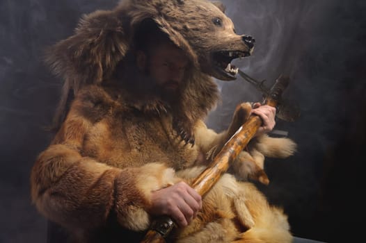 man with a bear's head, clothes made from the skin of an animal. Warrior cosplay costume