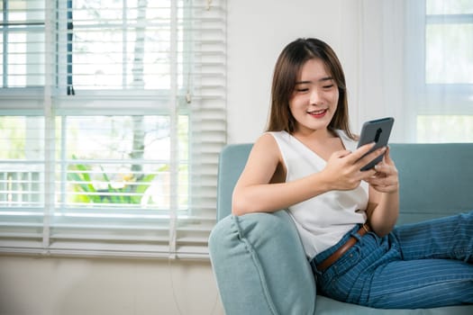 Happy young woman relaxed and messaging smartphone