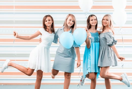 Beautiful girls holding balloons