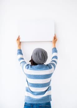 Girl holding blank canvas