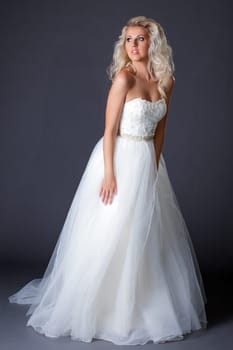 Romantic model posing in fashionable wedding dress