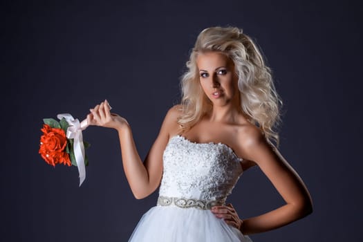 Portrait of pretty curly blonde in wedding dress