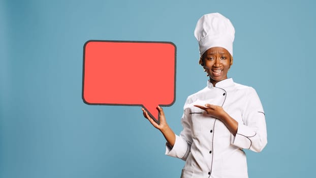 Young woman cook holding red speech bubble