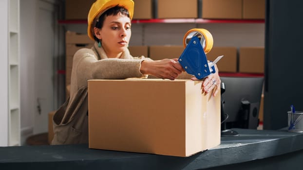 Depot worker sealing off packages of stock goods