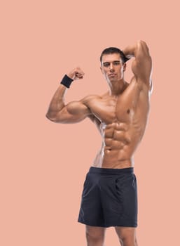 Man athlete isolated on a beige background. Gym full body workout. Muscular man athlete in fitness gym have heavy workout. Sports trainer on training. Fitness motivation.