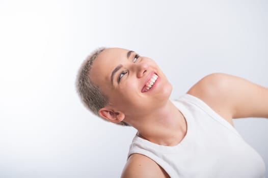 Beautiful young caucasian woman with a short haircut on a white background.