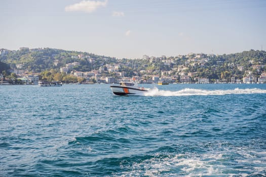 police boat going on the sea and wave behind it, police boat on bosphorus, police chasing criminal at sea, white wave