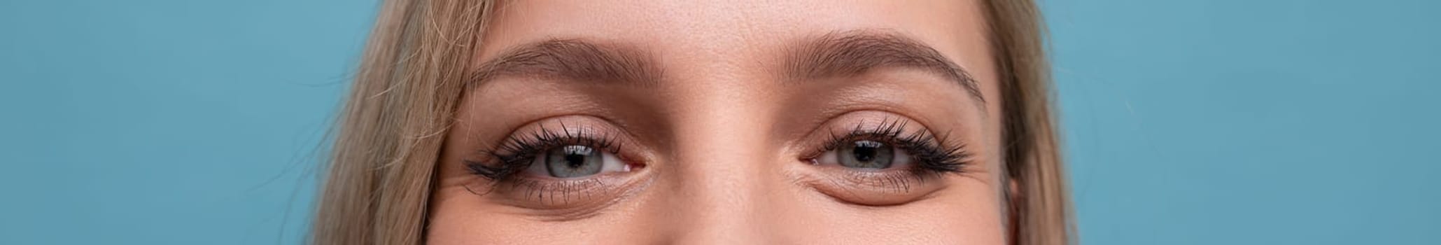 horizontal wide closeup photo of stunning female eyes in love