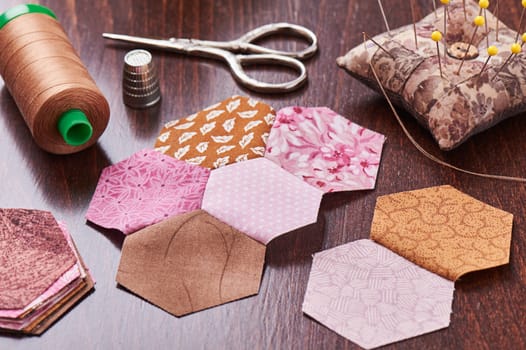 Sewing of hexagon pieces of fabric a quilt Grandmother's Flower Garden