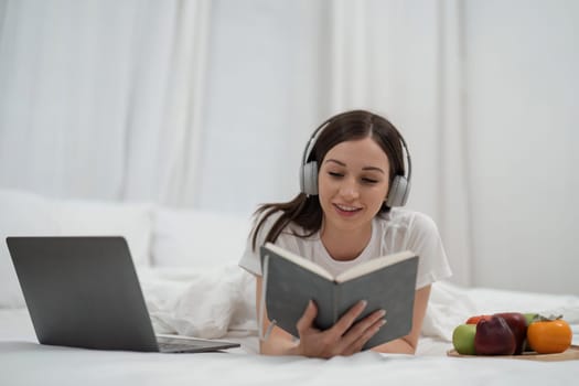 Relaxed women read books and Listen to your laptop music and morning fruits for holidays