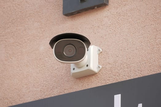 CCTV security camera operating on wall
