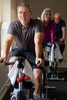 Dedicate to fitness no matter your age. a group of seniors having a spinning class at the gym