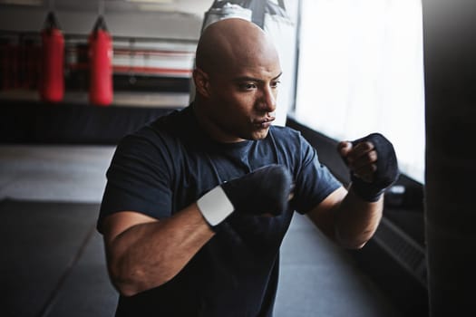 Im not a survivor, Im a warrior. a kick-boxer training in a gym.