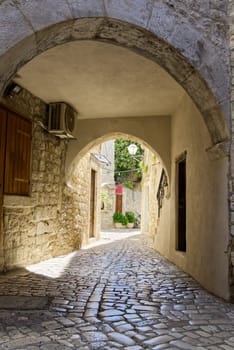 Narrow street with stone houses. Old houses and old narrow alley in Trogir, Croatia, Europe