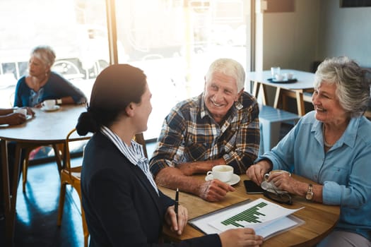 We feel confident about our decisions over the years. a senior couple meeting up with a financial advisor.