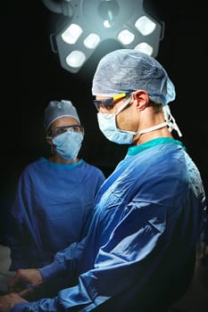 Trust in their treatment. two doctors against a dark background.